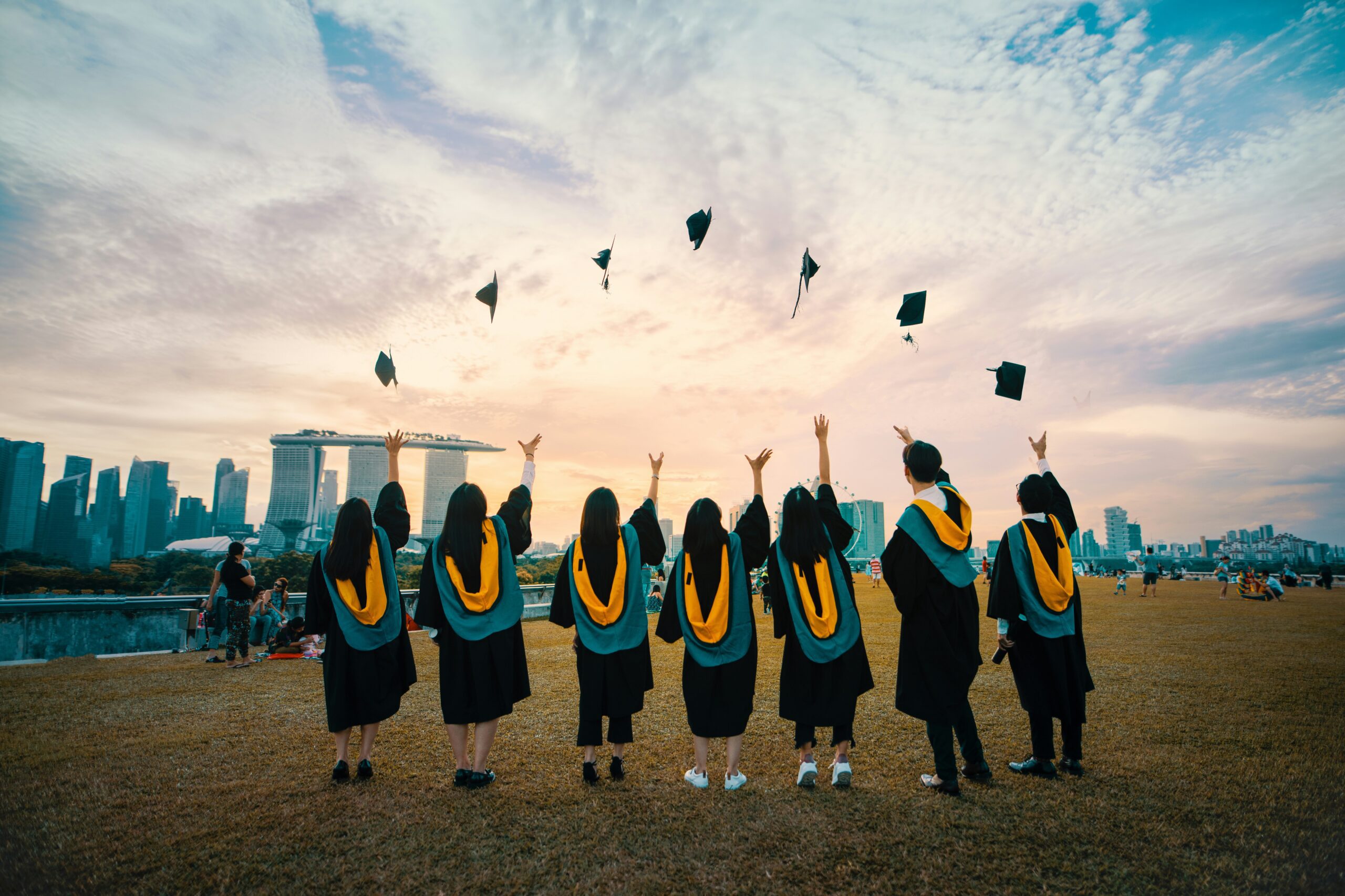college graduates tossing cap in air